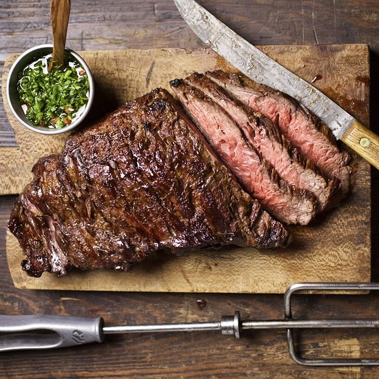 Fogo de Chão Brazilian Steakhouse signature dishes Picanha (Prime part of the Top Sirloin), Fraldinha (Bottom Sirloin), Cordeiro (Lamb), Costela (Beef Ribs), extensive Market Table selections, Pão de Queijo (Brazilian cheese bread).